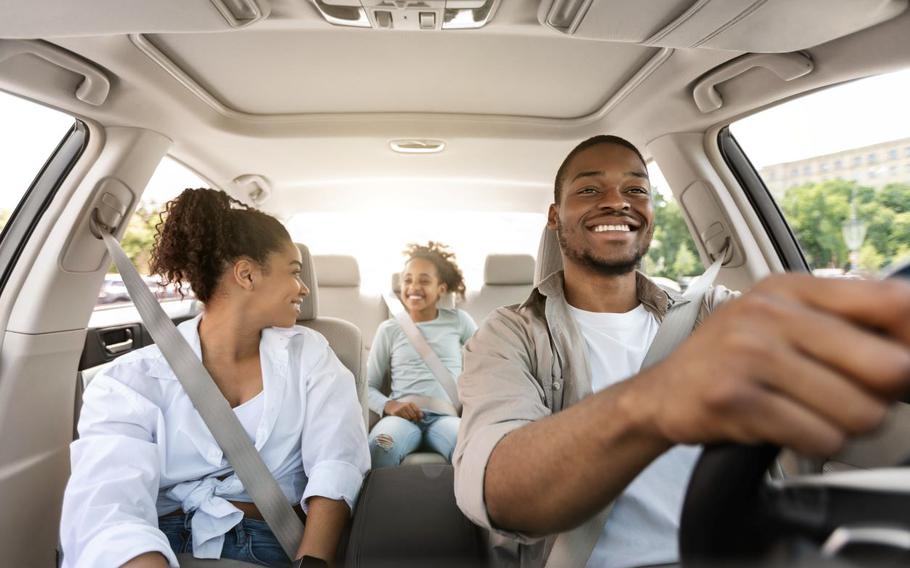 Parents with child in car