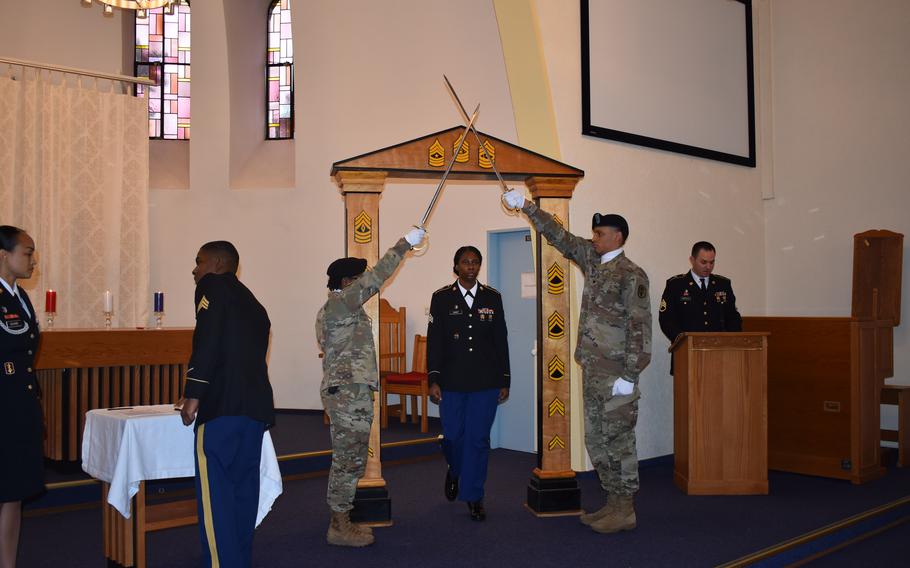 U.S. Army Sgt. Diane Cadet walks through the NCO arch Jan. 31 during an NCO Induction Ceremony at Landstuhl Regional Medical Center. (Photo Credit: Michelle Thum)