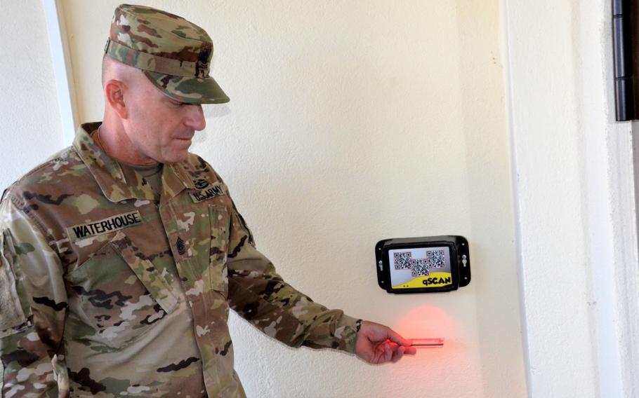 Photo By Erinn Burgess | U.S. Army Garrison Rheinland-Pfalz Command Sgt. Maj. Brett Waterhouse scans his ID card for after-hours access to Landstuhl Fitness Center