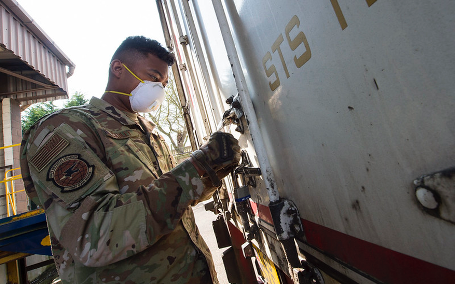 U.S. Air Force Airman 1st Class Andrew Cauley, a mail processing specialist with the USAFE- AFAFRICA Air Postal Squadron, Detachment Five, secures a transport truck as he prepares packages for transportation from RAF Alconbury, England on April 10, 2020. The Detachment Five postal team continue to maintain operational readiness during COVID 19 as the central postal distribution hub for U.S. service members stationed in the United Kingdom. (U.S. Air Force photo by Master Sgt. Brian Kimball)