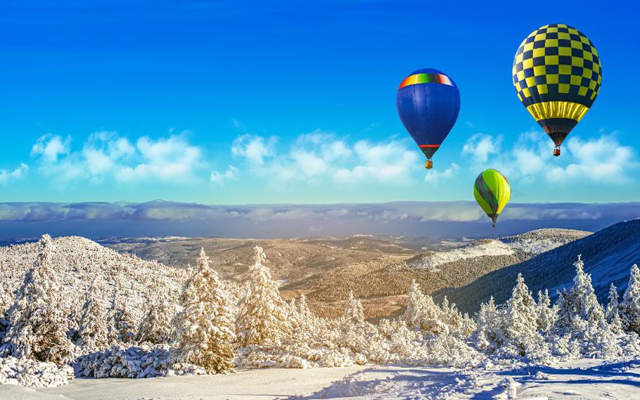 A balloon flies against the sky.