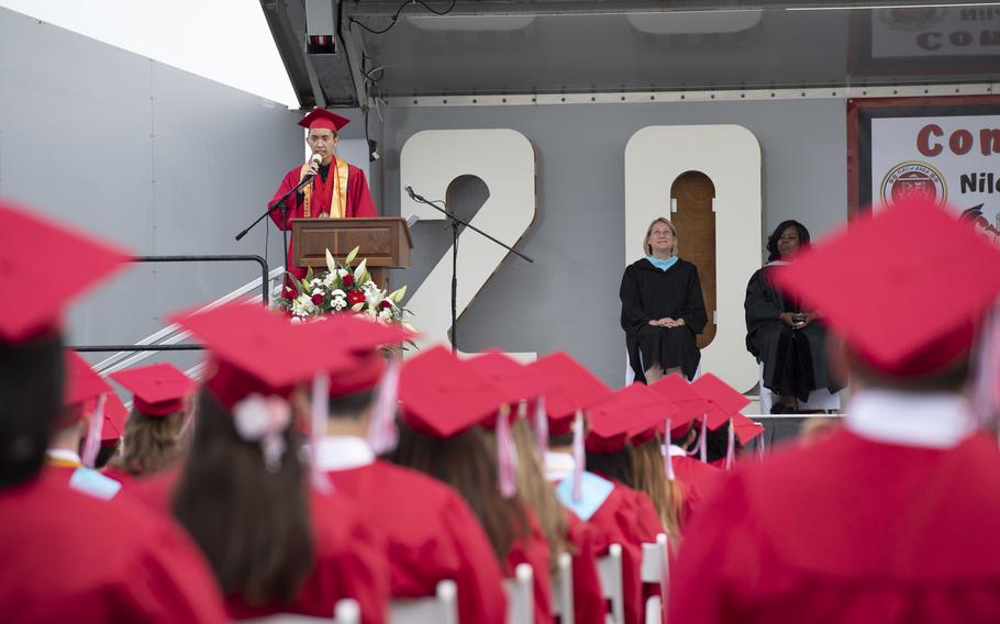 Photo by Petty Officer 2nd Class Kaleb Sarten. Speaker at high school graduation.